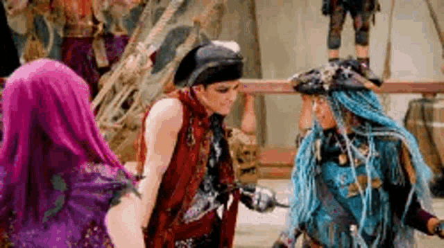a group of people dressed in pirate costumes are standing next to each other in a room .