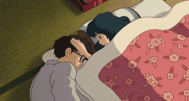 a man touches a woman 's forehead in bed