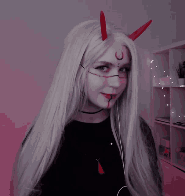a girl with long white hair and red horns on her head