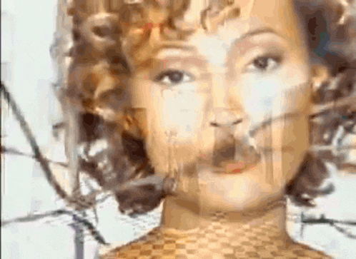 a close up of a woman 's face with a reflection of her face in a mirror .