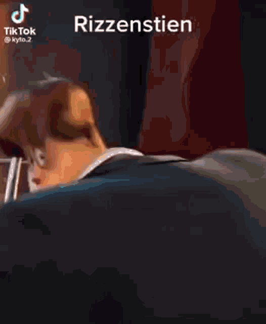a close up of a man 's face with the word rizzenstien on the bottom