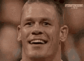 a close up of a man 's face with a smile on it .