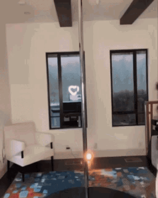 a living room with a chair and a pole