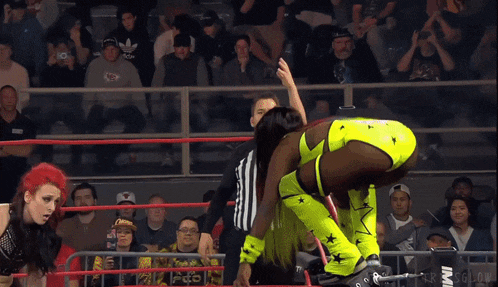 a female wrestler in a ring with a referee and the word act on the side