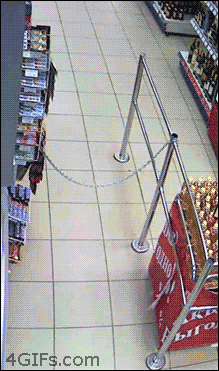 a person is chained to a railing in a store with a 4gifs.com logo in the corner