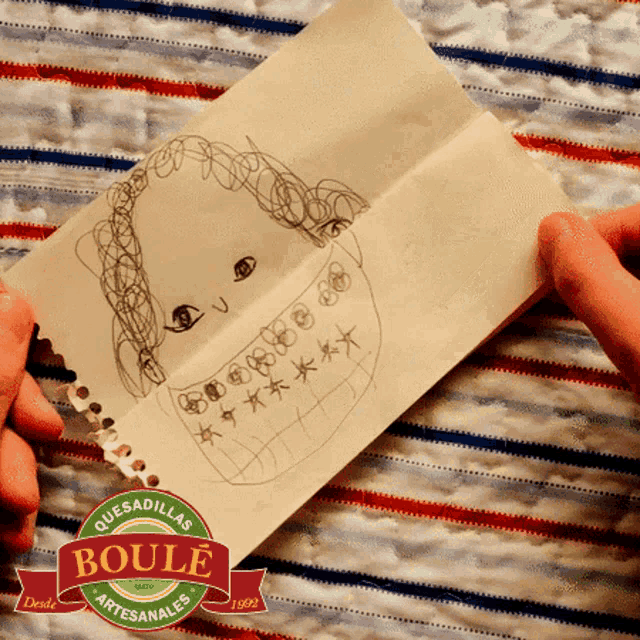 a person is holding a piece of paper that says quesadillas boule artesanales on it