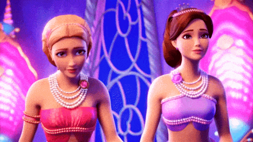 two barbie dolls are standing next to each other in a room .