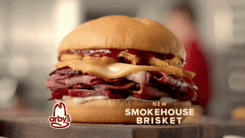 a smokehouse brisket sandwich from arby 's on a cutting board