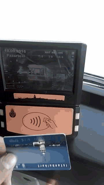 a person is using a istanbulkart card to pay