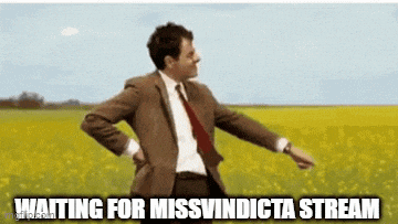 a man in a suit and tie is standing in a field with his hands on his back .