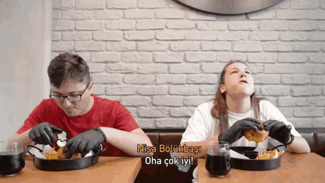 a man and a woman are sitting at a table eating food with nisa bolukbasi written on the bottom