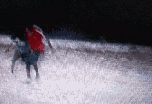 a blurry picture of a person in a red shirt running