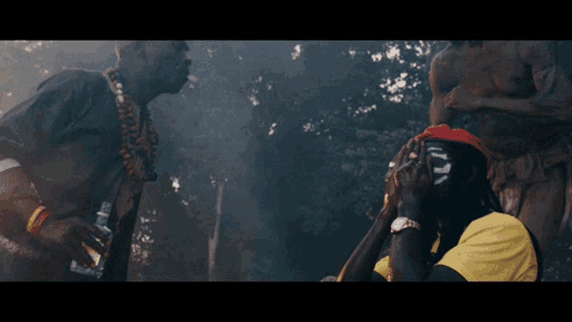 a man spraying another man with a bottle of liquid
