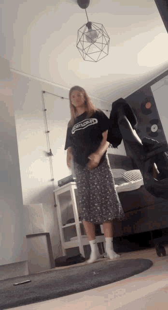 a woman wearing a black shirt that says ' compassion ' on it