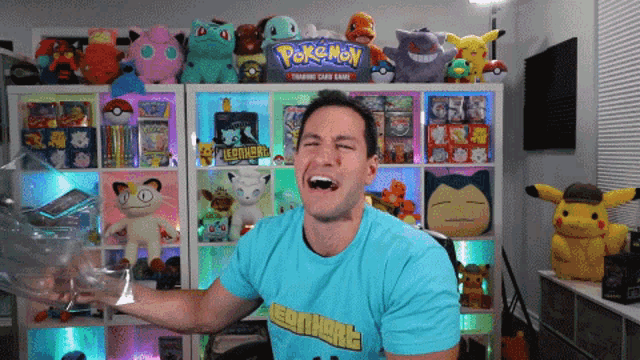 a man wearing a pokemon t-shirt is holding a plastic bag