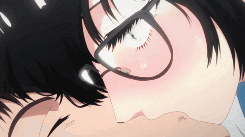 a close up of a person wearing glasses kissing