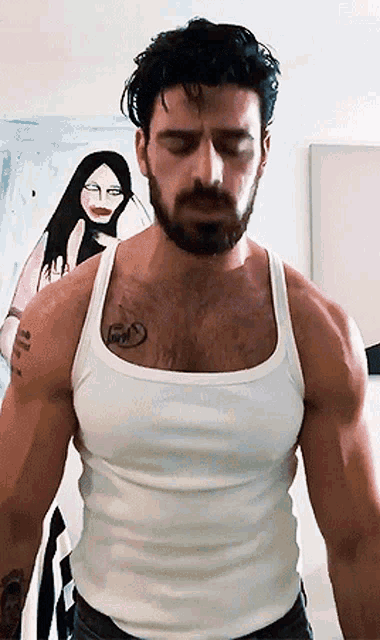 a man with a beard is wearing a white tank top and has a tattoo on his chest that says " love "