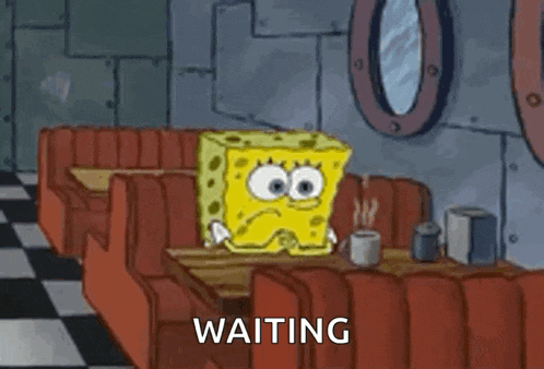 a cartoon of spongebob squarepants sitting at a table in a diner .