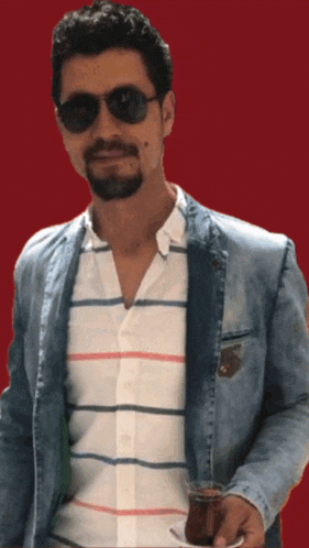 a man wearing sunglasses is holding a cup of tea