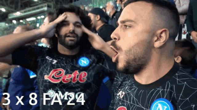 a man wearing a shirt that says cete holds his hand to his forehead