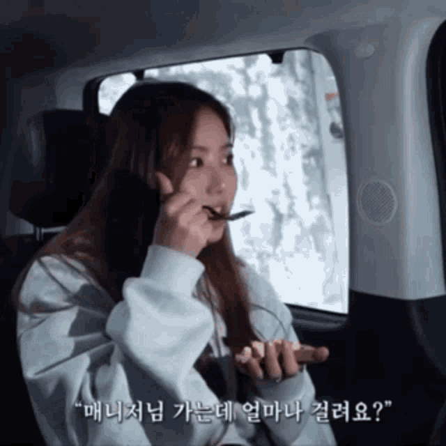a woman in a car with a spoon in her mouth