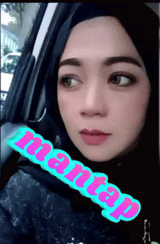 a woman wearing a hijab is sitting in a car and the word mantap is on the side of her face