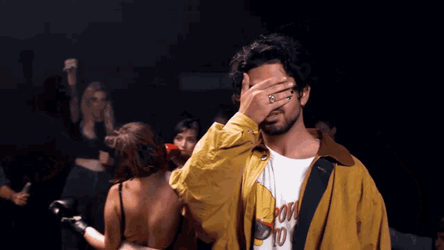 a man wearing a yellow jacket and a t-shirt that says born to love