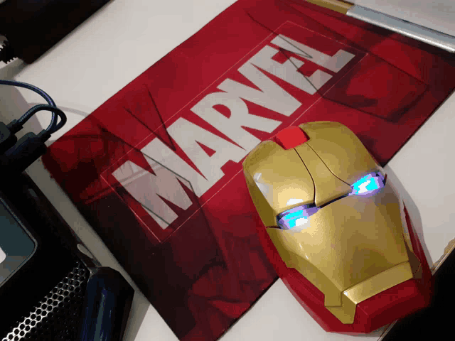 a marvel mouse sits on top of a marvel mouse mat