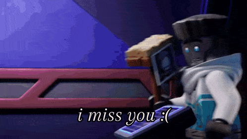 a ninjago character is holding a brush and saying `` i miss you '' while holding a remote control .
