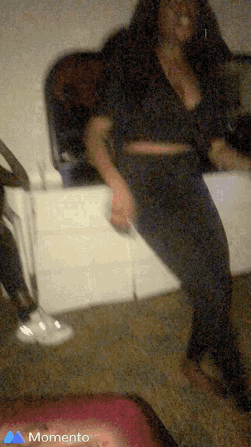 a blurry picture of a woman dancing with the word momento on the bottom right