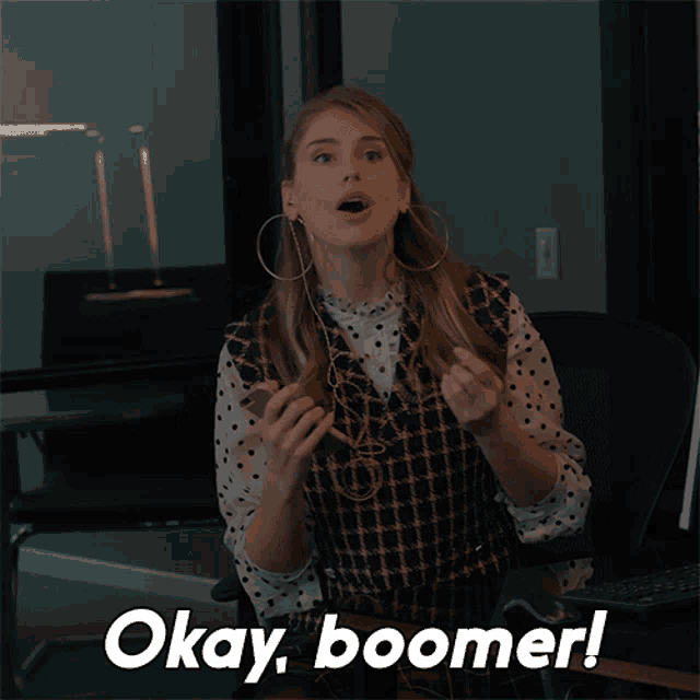a woman sitting in a chair with okay boomer written on the bottom