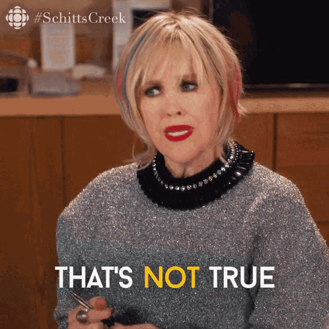 a woman is holding a pair of scissors with the words that 's not true below her