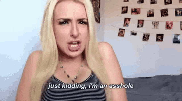 a blonde woman is making a face and saying `` just kidding , i 'm an asshole '' .