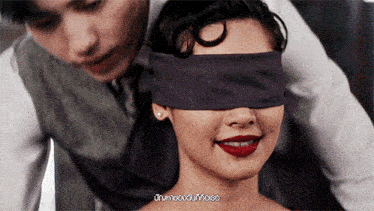 a man covering a woman 's eyes with a purple blindfold with a caption that says ' unanswerable '