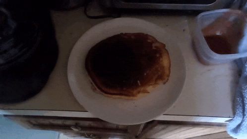 a white plate with a pancake on it on a counter top