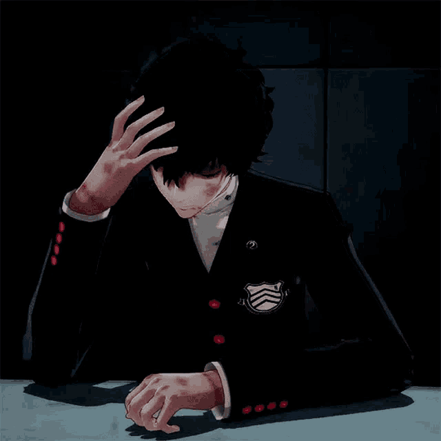 a man in a black suit is sitting at a table with his hand on his forehead