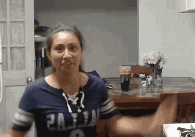 a woman wearing a jersey that says ' washington redskins ' on it
