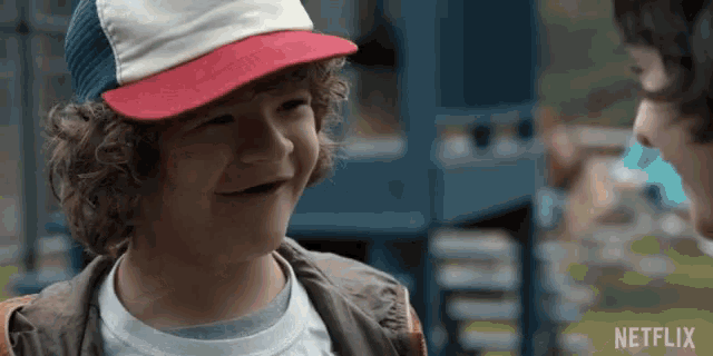 a young boy wearing a hat and a netflix logo on the bottom