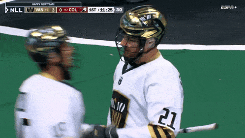 a hockey player with the number 21 on his jersey talks to another player