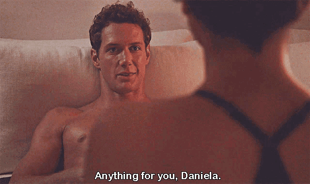 a shirtless man laying on a bed talking to a woman who says " anything for you "