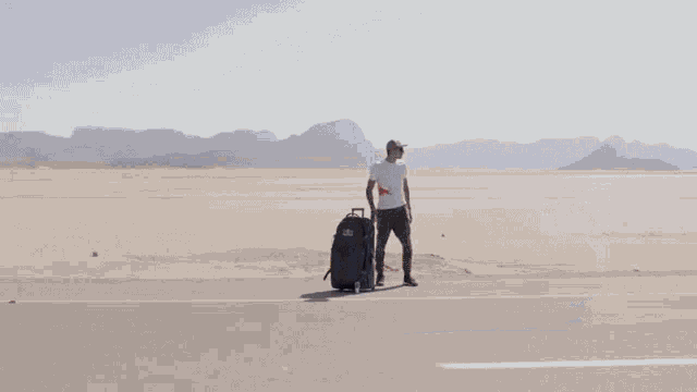 a man is standing next to a red bull racing car