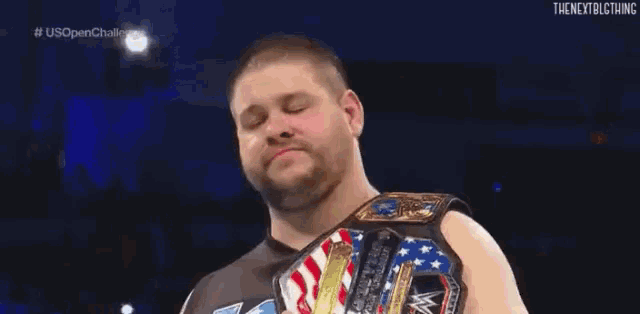 a man is wearing a wrestling belt with the word wwe on it