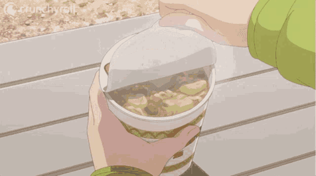 a person is holding a cup of noodles with crunchyroll written on the bottom