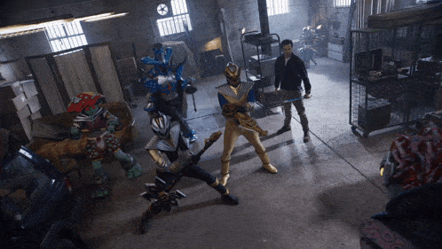 a group of teenage mutant ninja turtles and a man standing in a room