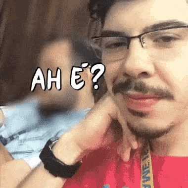 a man wearing glasses and a red shirt with a yellow lanyard that says june on it