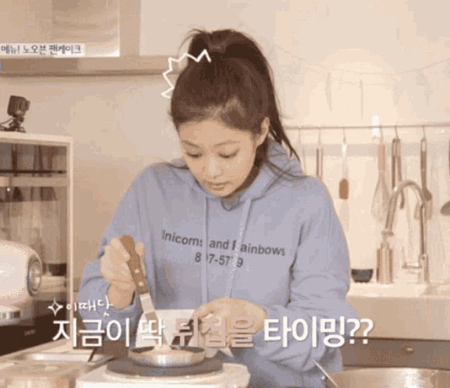 a woman wearing a blue hoodie that says unicorn and rainbows