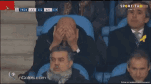 a group of men are watching a soccer game on a sport tv channel