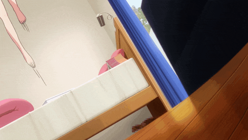 a bedroom with a bed and a window with a blue curtain