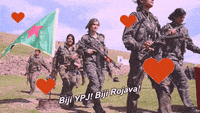a group of soldiers marching with the words bijl ypj bij rojava