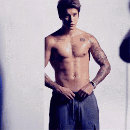 a shirtless man with a tattoo on his chest that says ' infinity '